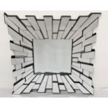 STARBURST WALL MIRROR with an inset central square plate surrounded by irregular shaped plates,