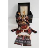 JAPANESE MINATURE SAMURAI WARRIOR SUIT OF ARMOUR comprising helmet, main suit and leg sections, with