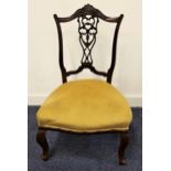 MAHOGANY NURSING CHAIR with a shaped top rail above a carved and pierced central splat with a
