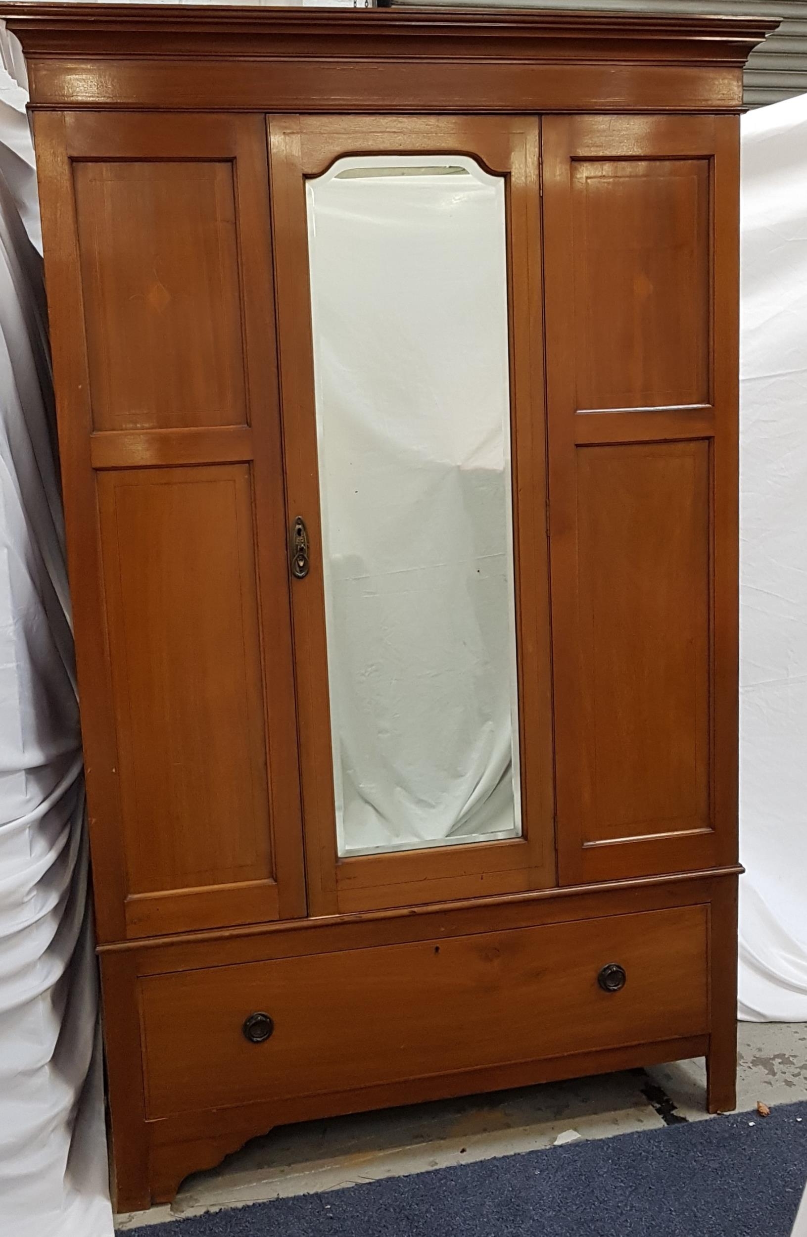 EDWARDIAN MAHOGANY AND INLAID WARDROBE with a moulded cornice above a central bevelled mirror door