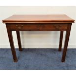 GEORGE III MAHOGANY TEA TABLE with a fold over top and swing out rear legs, and a frieze drawer,
