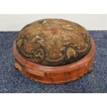 VICTORIAN WALNUT FOOTSTOOL with a circular needlework padded top on a circular frame with three