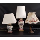 THREE TABLE LAMPS one raised on an hexagonal base with a porcelain body decorated with flowers, with