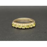 PERIDOT HALF ETERNITY RING the seven round cut peridots totalling approximately 0.5cts on a nine