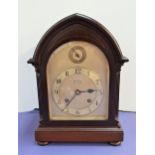 EARLY 20th CENTURY MAHOGANY BRACKET CLOCK in an arched case with a shaped silvered dial marked '