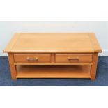 LIGHT OAK OCCASIONAL TABLE with a rectangular top above two frieze drawers with a shelf below,