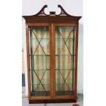 MAHOGANY DISPLAY CABINET with a carved swan neck pediment above a pair of astragal glazed doors