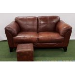 BROWN LEATHER SOFA with rollover arms, standing on stout shaped supports, 170cm long, together