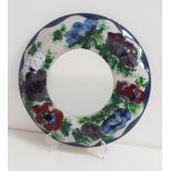 HIGHLAND STONEWARE WALL MIRROR in a circular frame decorated with poppies, 34.5cm diameter