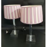 PAIR OF LAMPS raised on a square chrome base with flattened chrome columns and mauve and cream