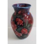 HIGHLAND STONEWARE VASE decorated with a blue ground and red flowers, 30.5cm high