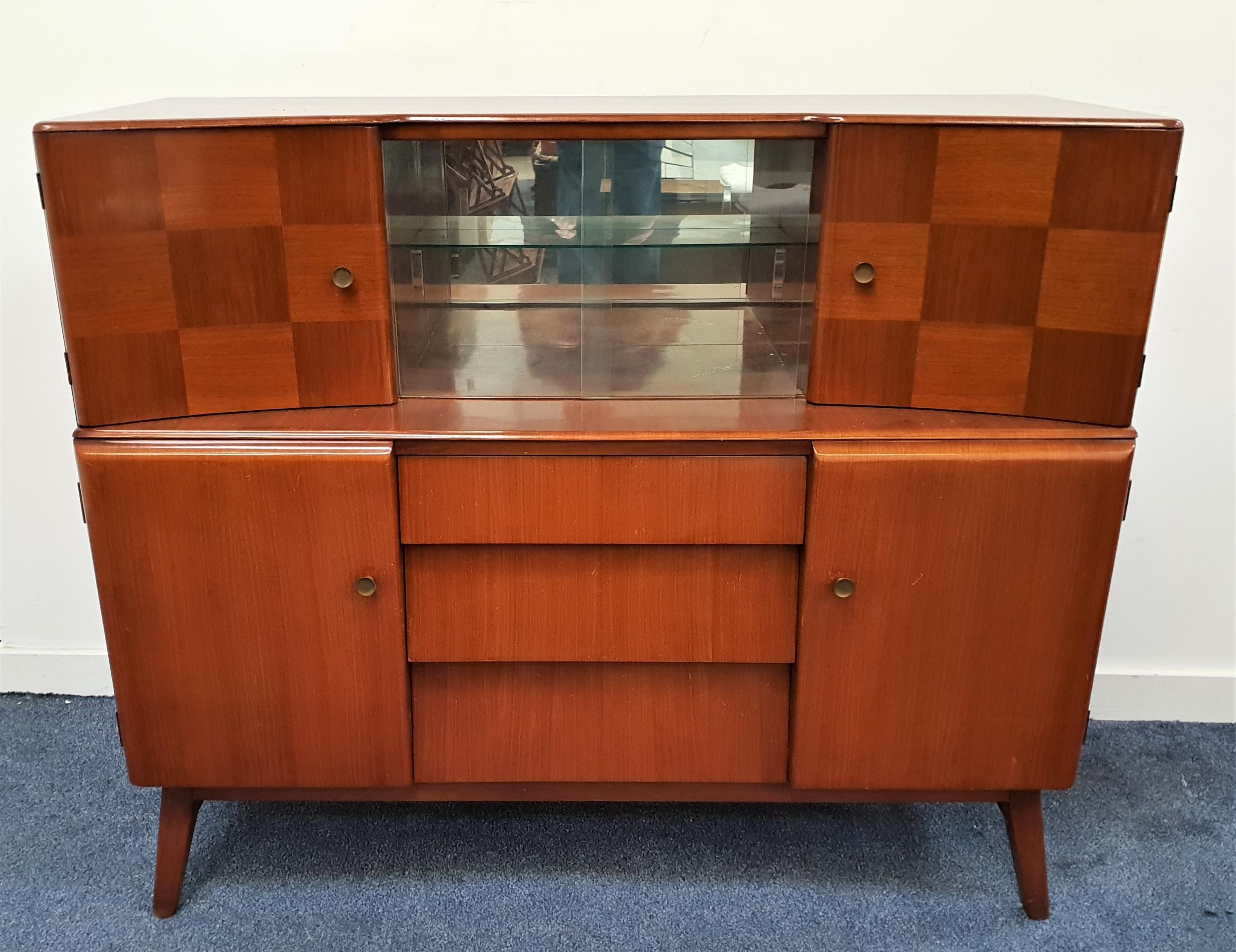 BEAUTILITY MAHOGANY DRINKS CABINET with a bow front above a pair of central glass sliding doors with