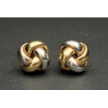 PAIR OF FOURTEEN CARAT TWO TONE GOLD STUD EARRINGS of entwined knot design, approximately 4.3