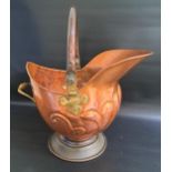 ARTS AND CRAFT COPPER COAL HELMET with a swing handle with brass hinges and a brass rear handle,