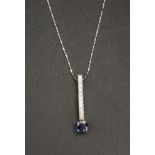 SAPPHIRE AND DIAMOND PENDANT the round cut sapphire approximately 0.5cts below a a row of eleven