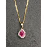 RUBY AND DIAMOND CLUSTER PENDANT the pear cut ruby approximately 0.5cts in diamond surround, in nine