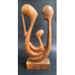 FESTUS IDEHEN (Nigerian b.1928) mother, father and child, carved teak, signed Festus to the base,