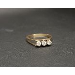 THREE STONE NINE CARAT GOLD RING the three CZ stones flanked by pierced shoulders, approximately 2.5