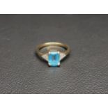 BLUE TOPAZ AND DIAMOND RING the central emerald cut blue topaz approximately 1.2cts flanked