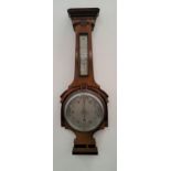 WALNUT ANEROID BAROMETER with a silvered thermometer above a circular silvered dial, 66.5cm high