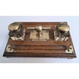 VICTORIAN OAK DESK SET with two glass inkwells and pen troughs with a central engraved