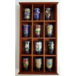 SET OF TWELVE CHINESE CLOISONNE BEAKERS each with a circular hardwood stand, in a wall mounted case