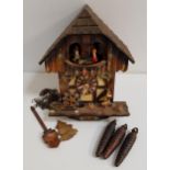BLACK FOREST CUCKOO CLOCK the circular dial with roman numerals, with pendulum and weights