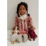 JUST LYNDA BLACK DOLL with porcelain head, arms and legs, with plaited hair, wearing a floral dress,