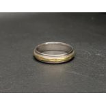 EIGHTEEN CARAT GOLD TWO-TONE BAND the white gold band with a yellow gold ring engraved with