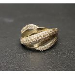 FOURTEEN CARAT GOLD RING the wave motif with alternating bands of gold and CZ set gold,