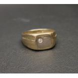 FOURTEEN CARAT GOLD SIGNET RING set with a CZ stone and with embossed shoulders, approximately 6.1