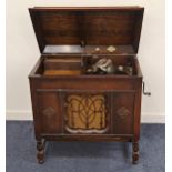 1930s GILBERT GRAMOPHONE in an oak case with a lift up lid above a sliding door opening to reveal