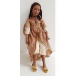 INGRID WINTER ENYA BLACK DOLL with porcelain head, arms and legs, with plaited hair, seated on a