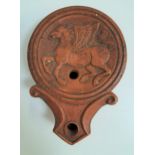 TERRACOTTA OIL LAMP decorated with Pegasus in relief, 11.5cm long