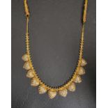 TWENTY-TWO CARAT GOLD NECKLACE the two-tone hanging hearts on a box chain with beaded accents,