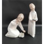 TWO LLADRO FIGURINES comprising Girl holding a candle 4868, 20.5cm high and Girl with slippers 4523,