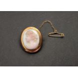 CARVED CORAL CAMEO BROOCH depicting a female bust in profile, in nine carat gold mount and with