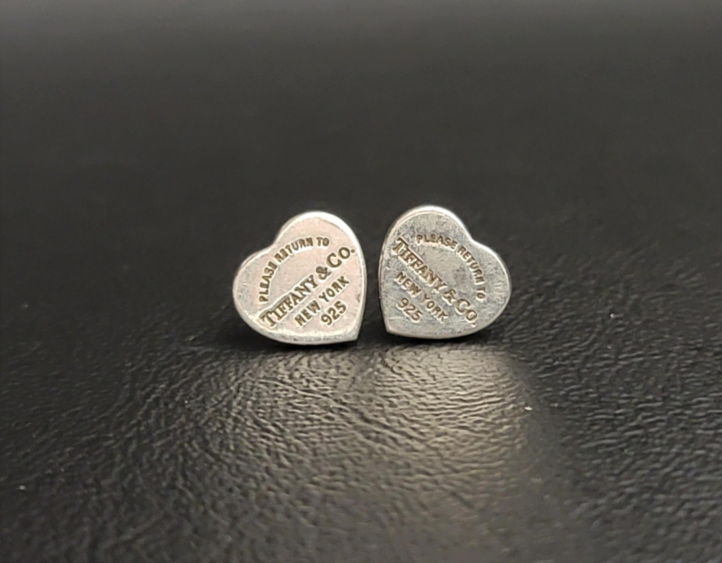 PAIR OF TIFFANY & CO. RETURN TO TIFFANY SILVER HEART TAG STUD EARRINGS Note: only one stud has the