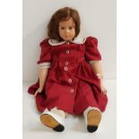 RUTH TREFFEISEN DOLL with a porcelain head, arms and legs, with long brown hair and wearing a