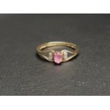 PRETTY DIMAOND AND PINK TOPAZ RING the raised oval cut pink topaz flanked by two diamonds either