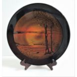 POOLE POTTERY AGEAN CHARGER with a dark brown border encasing a sunset over fields, 35cm diameter