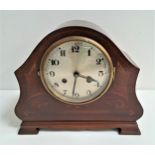 EDWARDIAN MAHOGANY AND INLAID MANTLE CLOCK with a shaped case and a circular silvered dial with