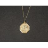 NINE CARAT GOLD ST. CHRISTOPHER PENDANT on a nine carat gold chain, approximately 2.1 grams