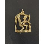 UNUSUAL EROTIC NINE CARAT GOLD PENDANT the male figure with articulated body seated behind the