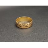 TWENTY-TWO CARAT GOLD BAND with floral and foliate motif, approximately 6.7 grams, ring size U-V