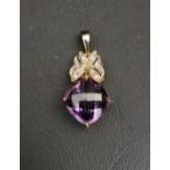 AMETHYST AND DIAMOND PENDANT the cushion briolette cut amethyst below diamond set stylised butterfly