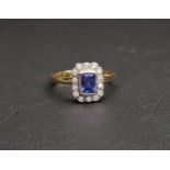 SAPPHIRE AND DIAMOND CLUSTER RING the emerald cut sapphire approximately 0.5cts in a fourteen