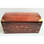 TEAK CASKET with floral brass inlay and side handles with a domed lid opening to reveal a lift out