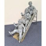 STEEL GARDEN ORNAMENT depicting three young children on a garden slide, painted grey, 110cm high