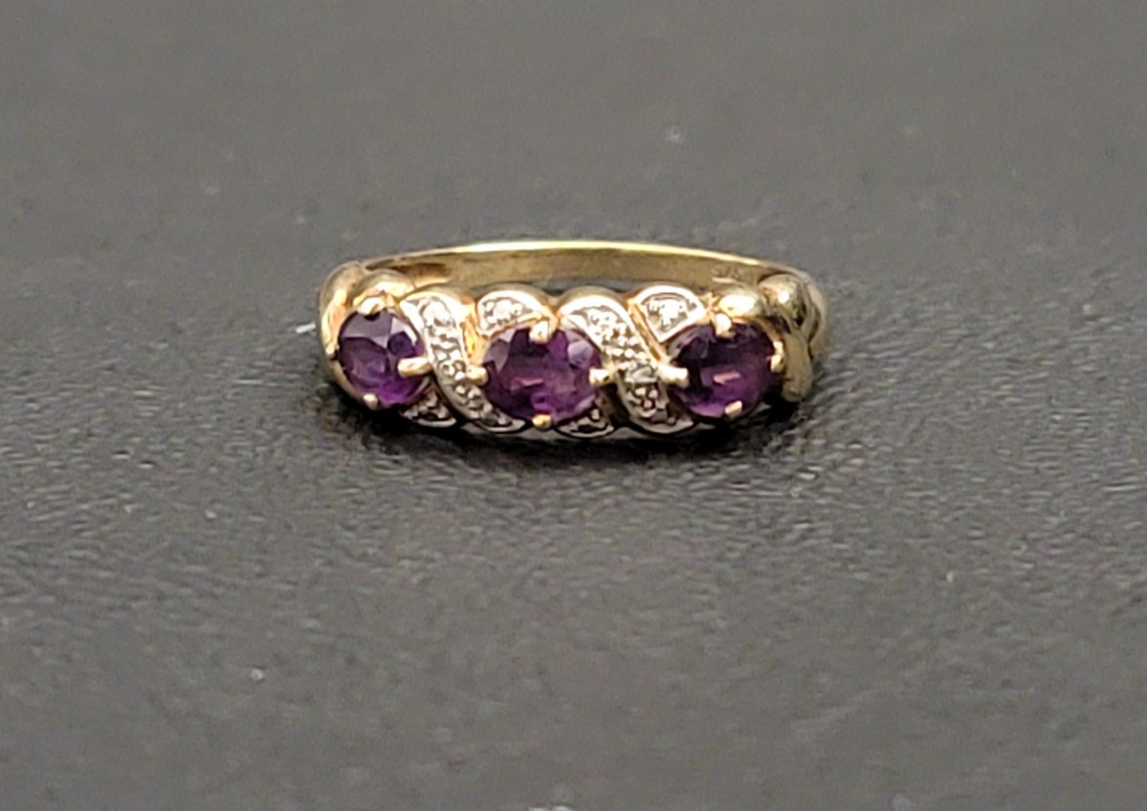 AMETHYST AND DIAMOND DRESS RING the three oval cut amethysts separated by small illusion set - Image 2 of 2